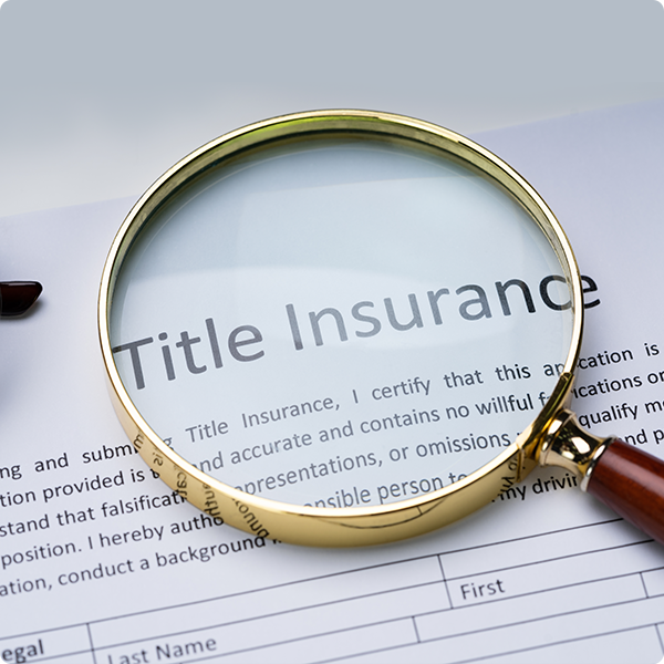 Title Insurance Policy being magnified with a magnifying glass.